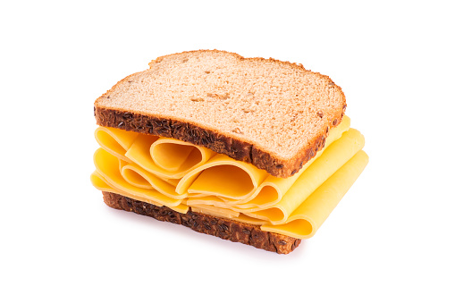 An appetizing view of a sandwich made with two slices of whole grain bread filled with seeds, layered with generous amounts of cheese, creating a delicious and irresistible combination of textures and flavors.