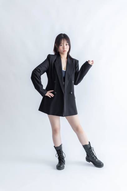 istock Asian woman in black suit and boots posing 2015741823