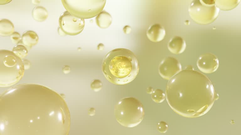 Numerous water bubbles rise in a macro image against a bright background.