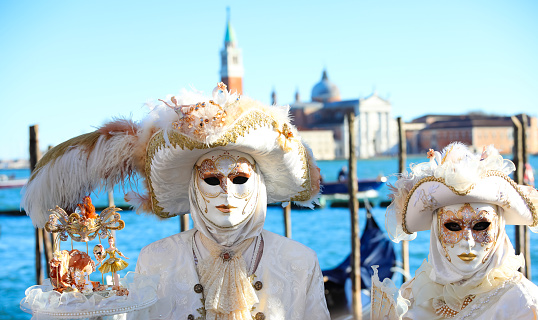 Musical mask. Venetian music carnival mask and old house at background. Venice, Italy.  Old times dark aged photo