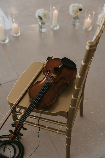 Violin on golden chair.