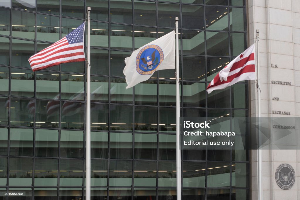 U.S. Securities and Exchange Commission (SEC) Washington, DC, USA - Jun 23, 2022: Waving flags of the United States, the SEC, and Washington, D.C. are seen in front of the U.S. Securities and Exchange Commission (SEC) headquarters building. Security Stock Photo U.S. Securities and Exchange Commission (SEC) Washington, DC, USA - Jun 23, 2022: Waving flags of the United States, the SEC, and Washington, D.C. are seen in front of the U.S. Securities and Exchange Commission (SEC) headquarters building. Security Stock Photo