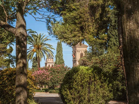 Granada, Andalucia, Spain - September 9, 2023: Tower of the church Iglesia de Santa Maria de la Encarnacion in the Alhambra, Granada, from the gardens of Generalife, summer vacation tourism, Andalusia, Spain
