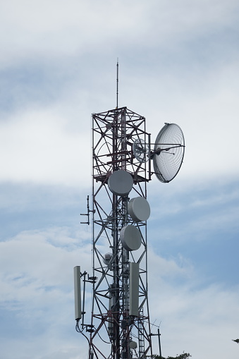 Soaring antenna tower against a clear sky background
