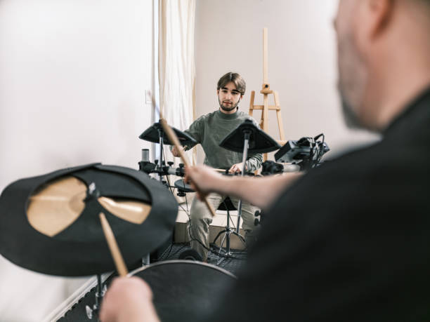istock Male music teacher at drumming music studio 2015861593