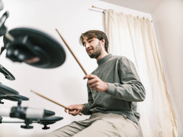 istock Male music student at drumming music studio 2015862124