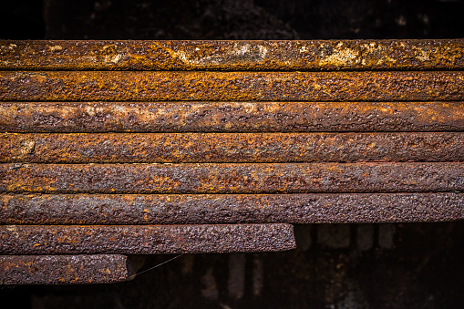 Close-up photo of old rusty machine parts, leaf springs.