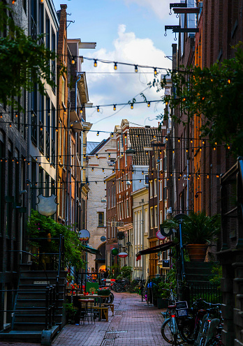 Fun Hidden Brick Street In Amsterdam With Restaurants and Bars With Hanging Lights And Parked Bikes