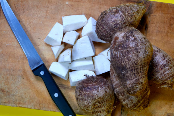 closeup of taro root vegetable, eddo malanga, yellow background - chinese eddo zdjęcia i obrazy z banku zdjęć