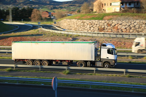 Road construction aggregate transport truck traveling on a highway in Spain. Concept: road transport