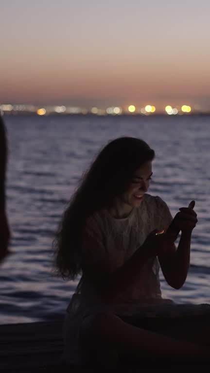 Boy takes a flash photo of his girlfriend in a beautiful sunset