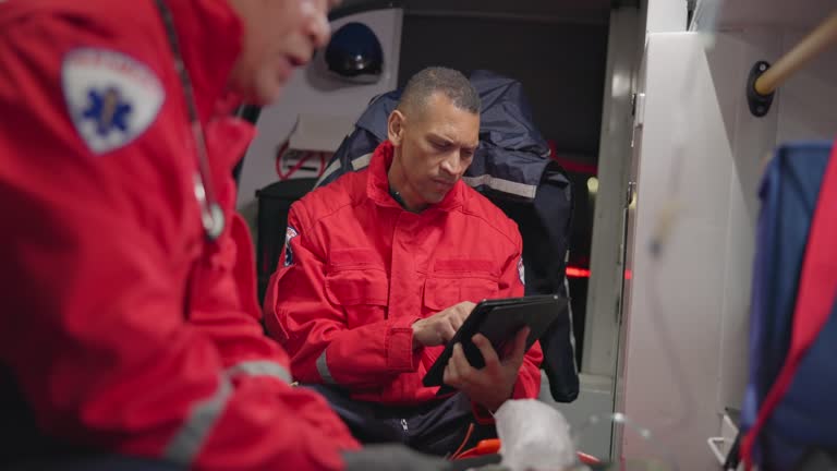 Talking, man and a tablet at sea for rescue team, communication and emergency at sea. Teamwork, digital and a medical employee working on a boat with technology for service, analysis or research