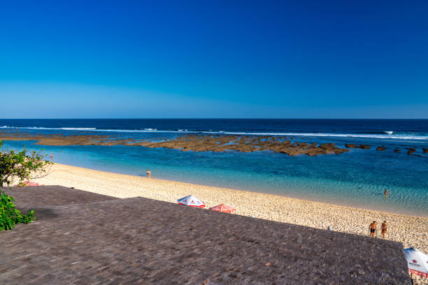 Bali, Indonesia - August 28, 2023: Tourists on Melasti Ungasan Beach.