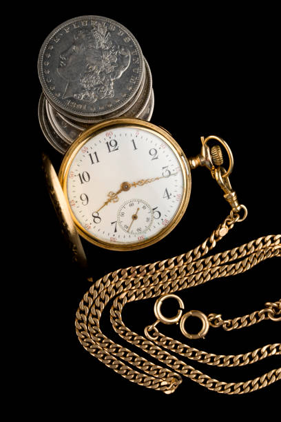 istock Antique pocket watch with antique silver dollars 2016011296