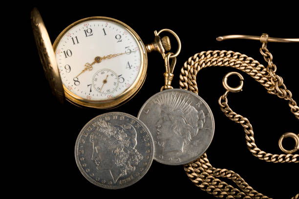 istock Antique pocket watch with two antique silver dollars 2016011299