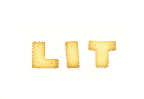 Capital letter shaped biscuits forming word lit isolated on white background