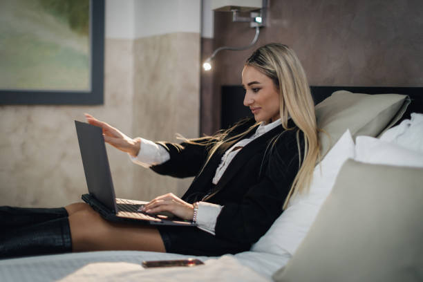 istock Businesswoman using a laptop in a hotel room 2016028807