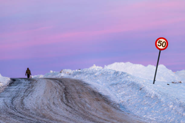 Arctic pink sunset on frozen road.\nHammerfest - Norway.