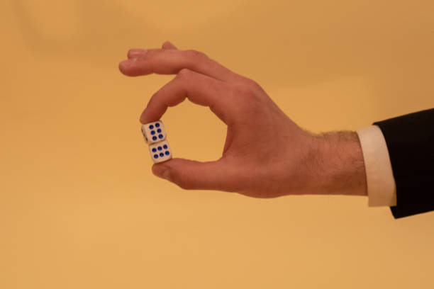 istock Man in suit holding gambling dice. 2016089997