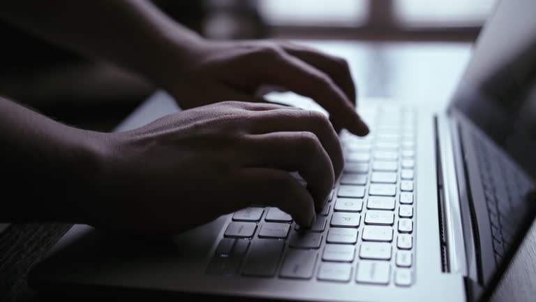 Late Hours Office: Close-Up of Woman Typing on Laptop