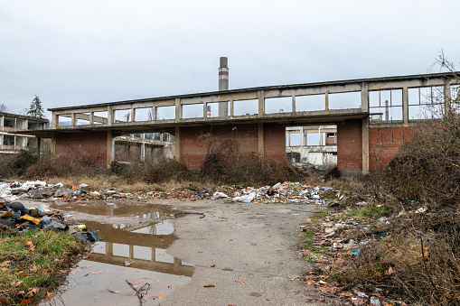 Remains of an old chemical factory looted dilapidated crumbling puddle water