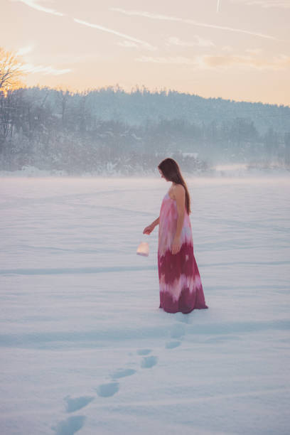 istock Young woman explores winter landscape with lantern 2016120832