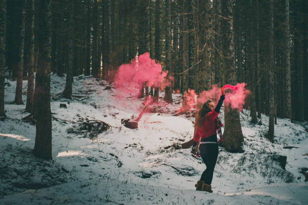 istock Young woman ignites flare in forest 2016123416
