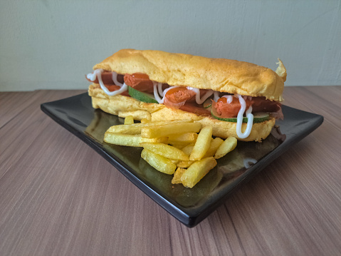 Hotdog And French Fries With Sausage, Cucumber, Ketchup And Mayonnaise On A Plate. Hot Dog Food Menu.