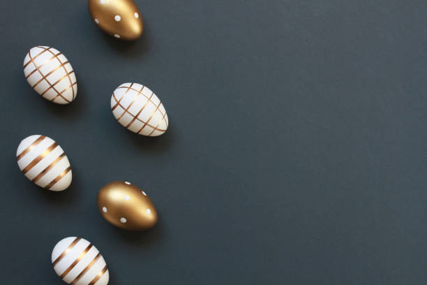 istock Elegant Easter eggs decorated with gold on dark gray blue background with copy space 2016197534