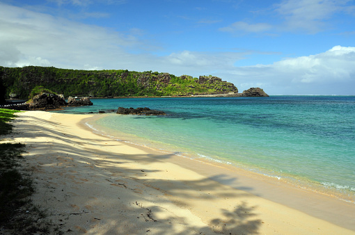 La Prairie, Black River district, Mauritius: golden sand beach on the south coast, looking eastwards with the B9 coastal road and the Macondé viewpoint in the background.