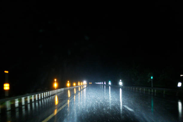 istock Long Straight Night Expressway Torrential Rain Motion Blur 2016244120