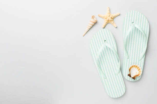 istock Striped flip flops on color background, top view 2016255017