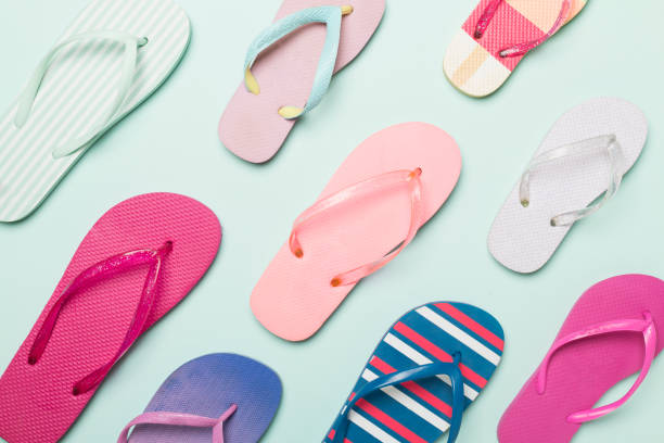 istock Bright flip flops on color background, top view 2016255024