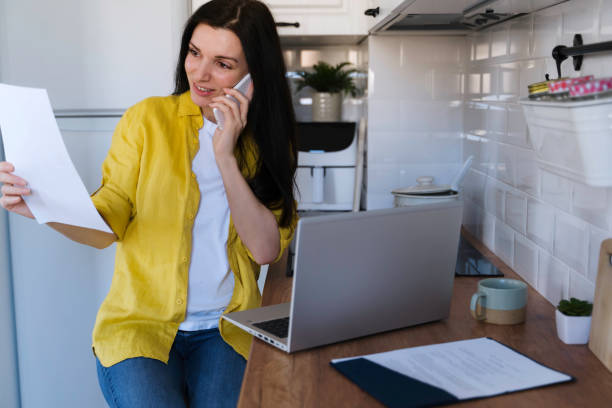 istock A woman using laptop in the morning in the kitchen  while having breakfast. 2016259150
