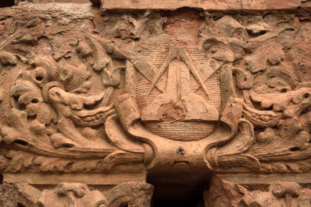 Weathered stonework on a building in on Front Street in downtown Wilmington, NC, features a Masonic symbol.