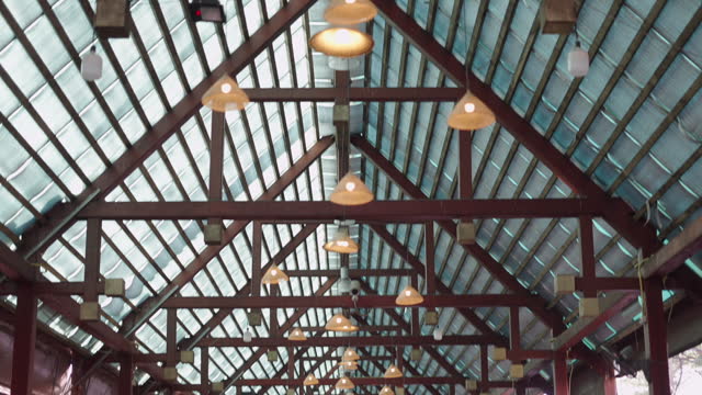 Floodlights on the roof of an indoor market in Thailand