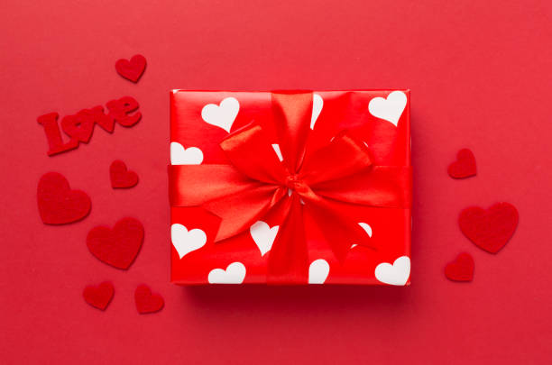 istock Gift box with hearts on color background, top view. Valentines day concept 2016266998