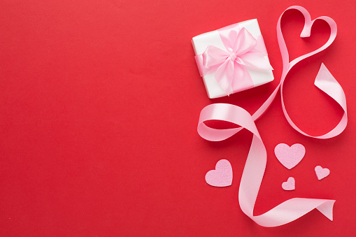 Valentines day composition with gifts on color background, top view.
