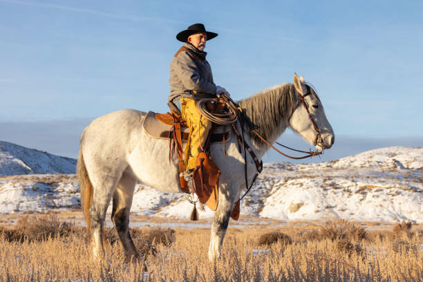 Horseback riding on a Wyoming horse ranch in the winter on a rural landscape.