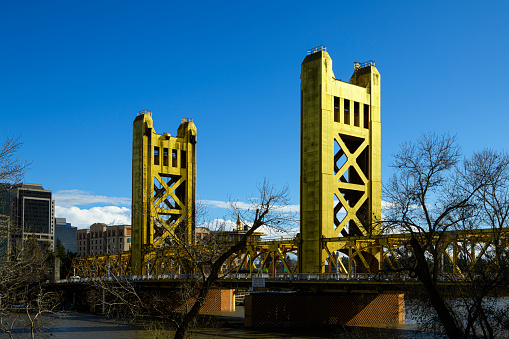 Low angle view of Sacramento's Historic Tower Bridge, over the Sacramento River, connecting East and West Sacramento.\n\nTaken in West Sacramento, California.