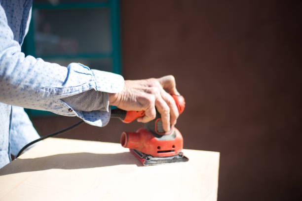 Man Sanding Wood with Electric Palm Sander