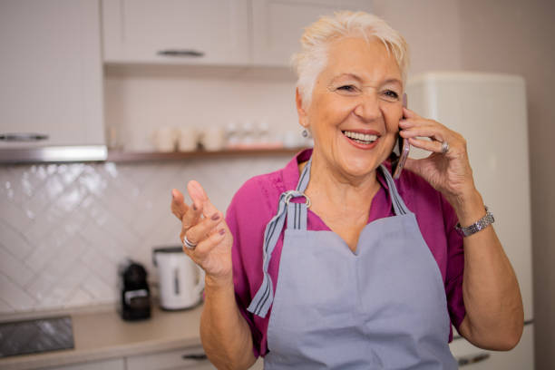 istock Happy senior woman using smartphone 2016367985