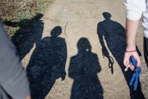 shadows of four unrecognizable people in rural nature