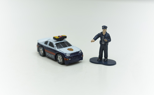 Miniature police man with police car