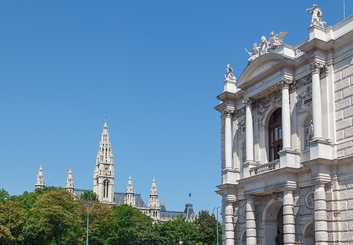 Detail of the towers of the Vienna City Hall and an ornate facade of a historical building, Austria