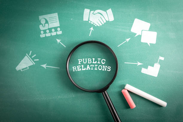 istock Public Relations. Magnifying glass on green school blackboard background 2016490255