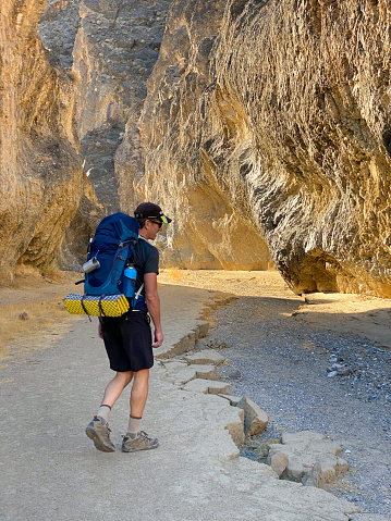 Man hiking in Cottonwood Canton, Death Valley California