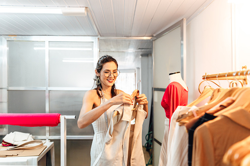 Stylist organizing clothes on hanger