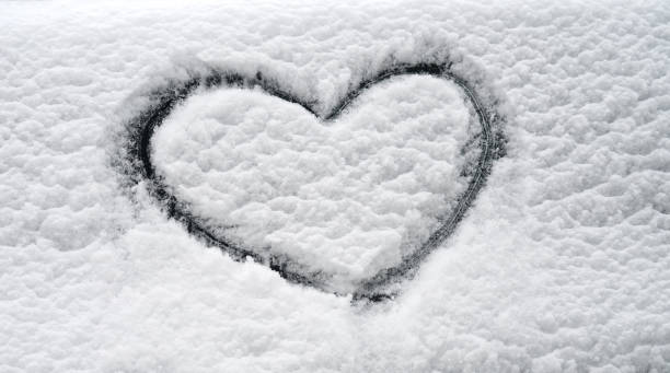 istock close up on drawing hearts on snow 2016556809