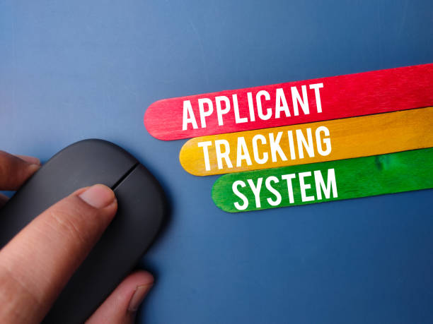 istock Wireless mouse and wooden stick with the word APPLICANT TRACKING SYSTEM 2016578758